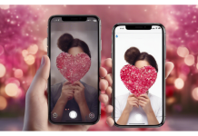 Mejores móviles por menos de 200€ para regalar en San Valentín Dos manos sosteniendo smartphones con fotos de corazones en un fondo rosa desenfocado para San Valentín